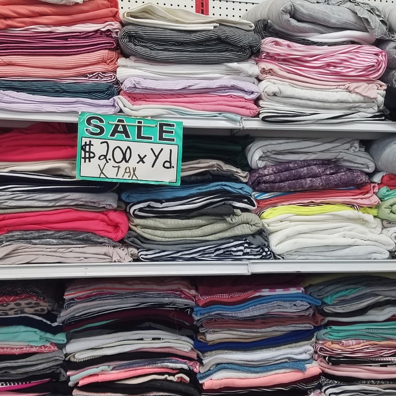 Shelves of colorful folded fabrics for sewing projects